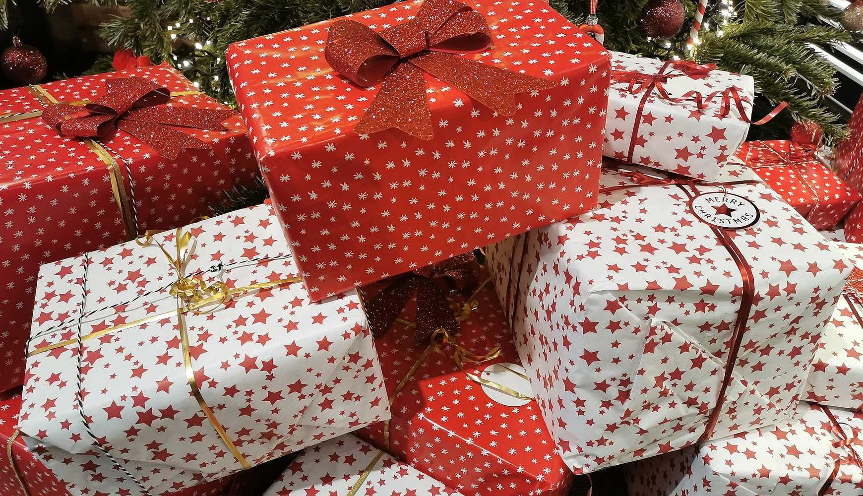
A pile of presents under a Christmas tree.
