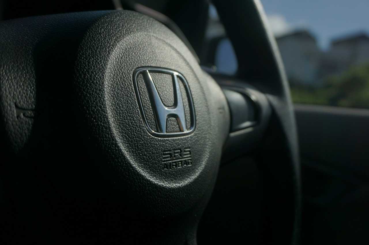 A steering wheel inside a Honda vehicle.