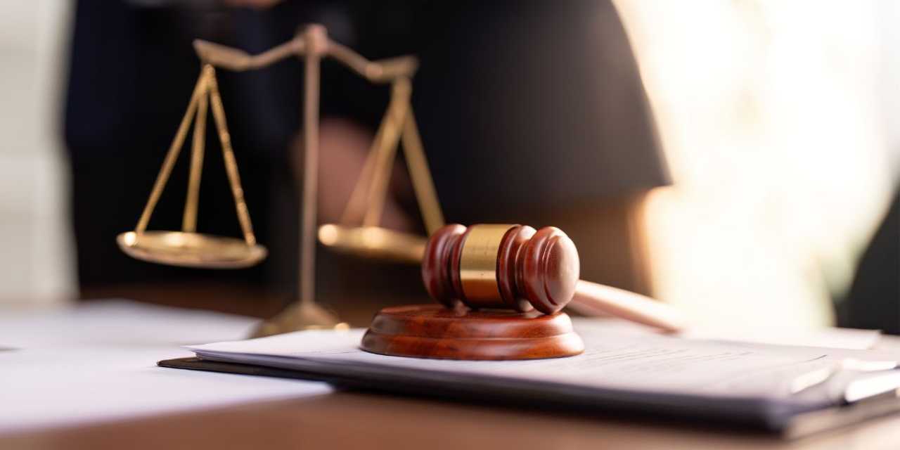 A legal scale and gavel. A legal scale and gavel.