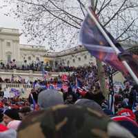 <p>The outside of the U.S. Capitol during the Jan. 6 insurrection. An "Appeal to Heaven" flag is seen carried by a rioter.</p>