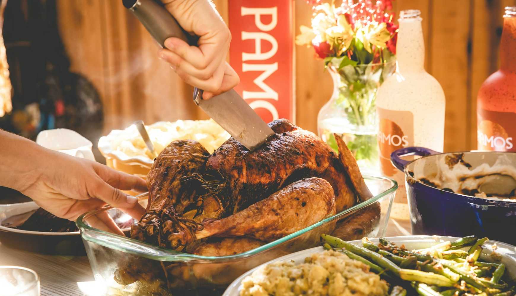 
A person cutting into a Thanksgiving turkey.
