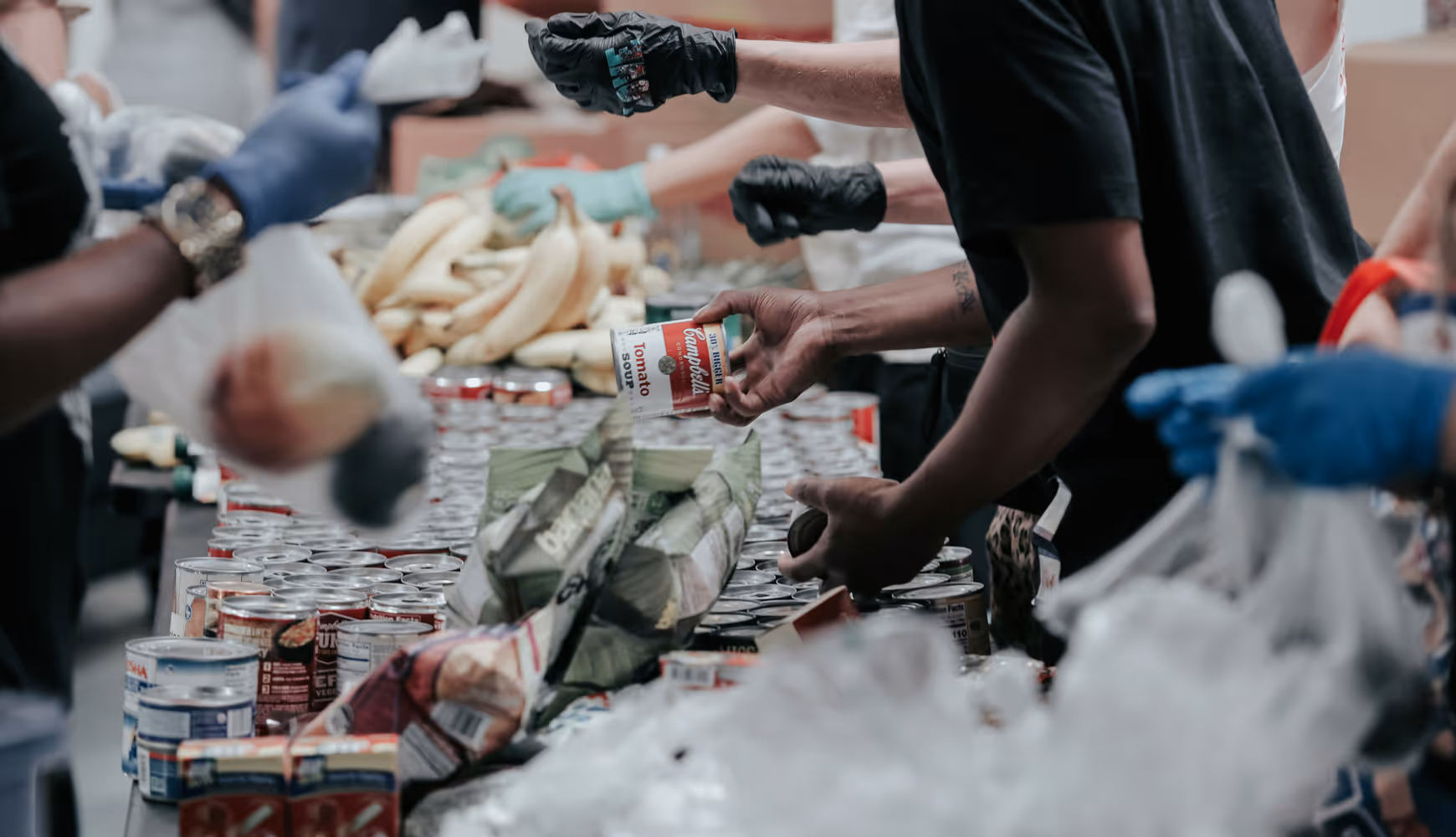 Volunteers handing out food at a food bank. 
 
Volunteers handing out food at a food bank.