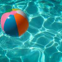 <p>A beach ball floating in a pool.</p>