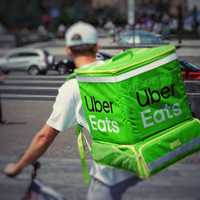 <p>A man delivering for Uber Eats on a bicycle.</p>