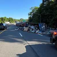 City Truck Carrying Waste Overturns On Thruway In Yonkers, Spills Trash