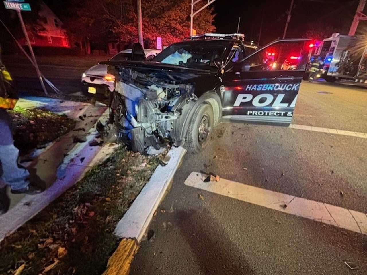 A Hackensack driver and a Hasbrouck Heights police officer were both hospitalized when the 64-year-old civilian ran a red light and struck the officer's police vehicle early Tuesday, Nov. 18, authorities said.