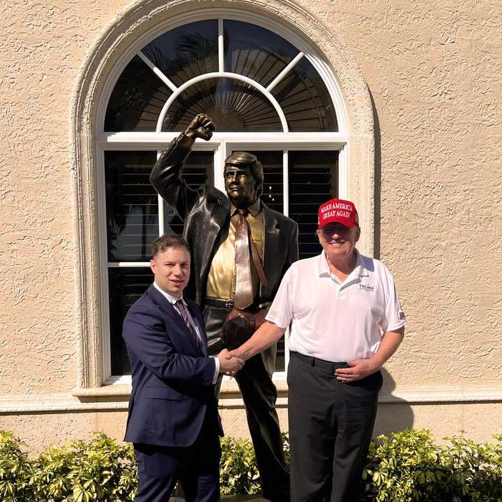Sticker Mule founder Anthony Constantino poses with President Donald Trump in front of the new Trump "Defiance" statue.&nbsp;