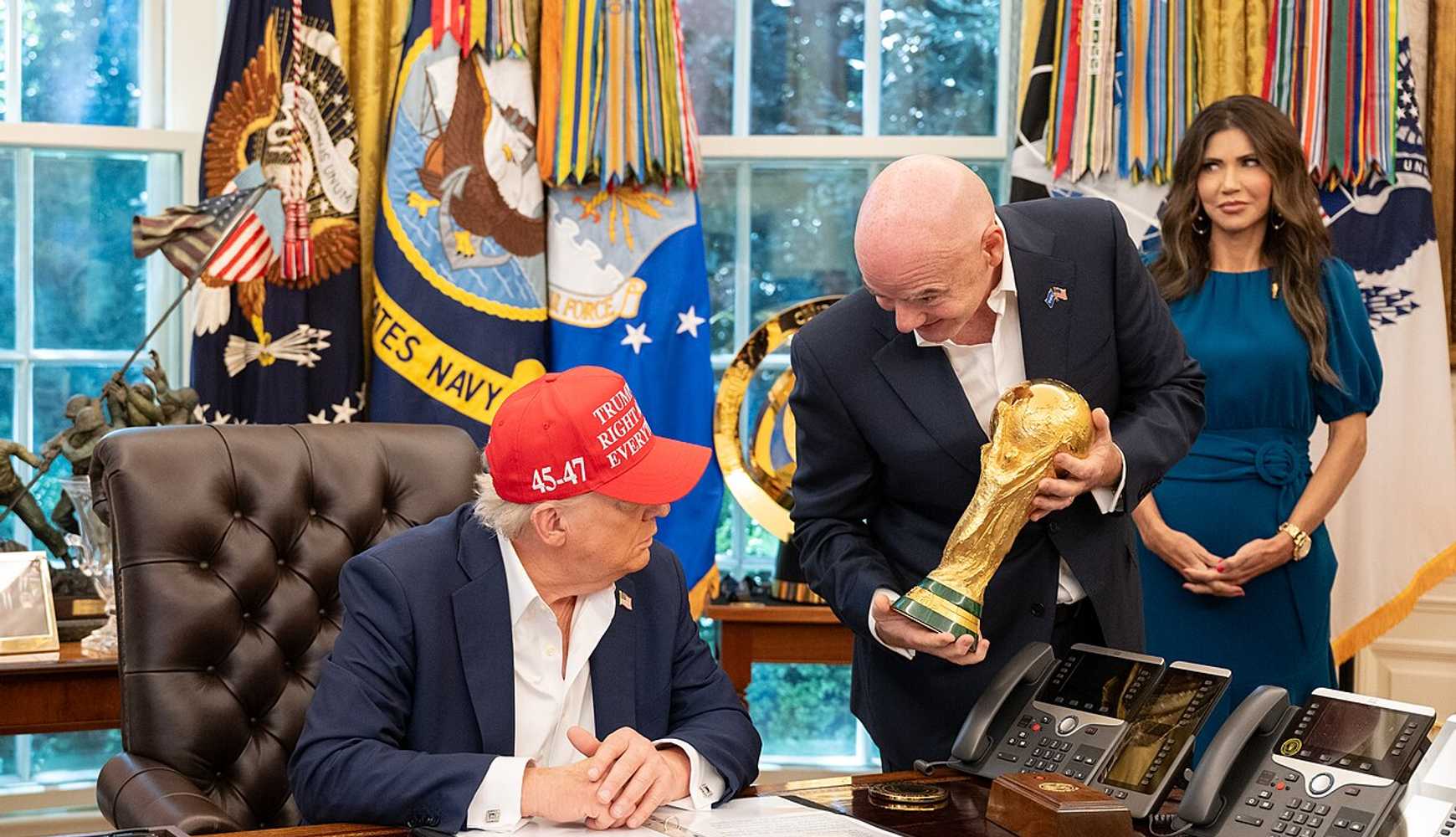 
FIFA President Gianni Infantino hands the men's World Cup trophy to US President Donald Trump during a White House meeting on August 22, 2025.
