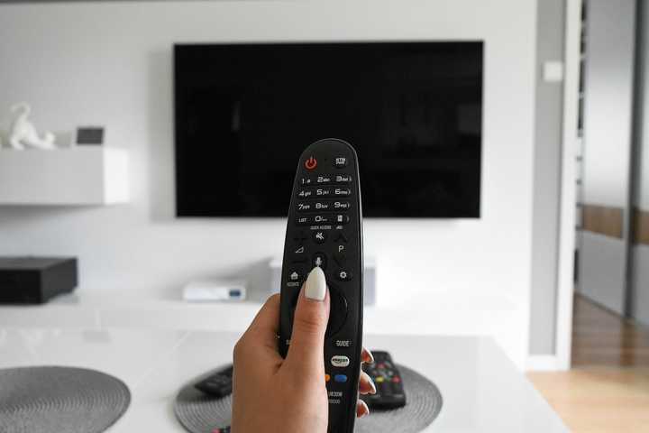 A person with a TV remote control.