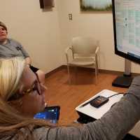 <p>Program manager Dana Dolce, APN, and Mary during a visit to JSUMC to calibrate her DBS system.</p>